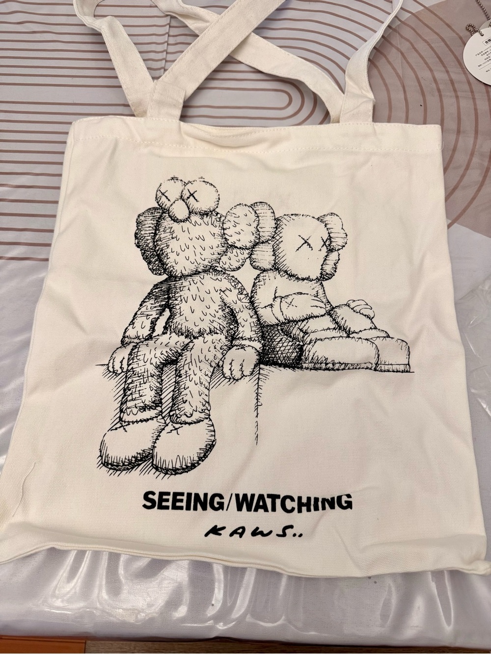 KAWS Cream and Black Graphic Tote with SEEING/WATCHING Print
